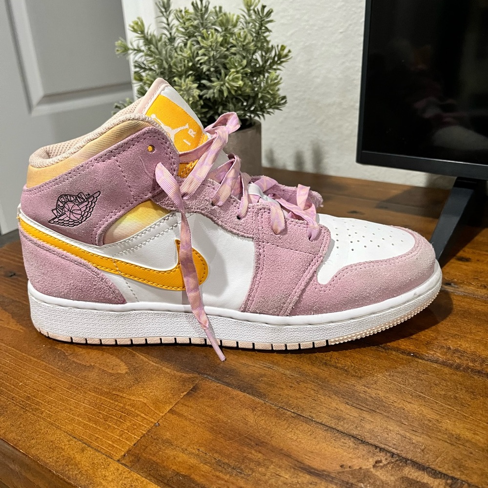 Pink and yellow Air Jordans slightly worn.